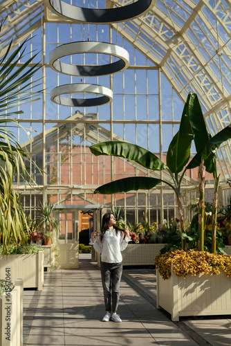 A Charming Greenhouse That Features an Abundance of Lush Tropical Plants and Natural Light