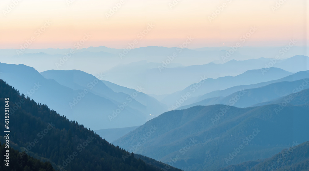 Obraz premium Mountain landscape with layered hills at sunset in blue tones 