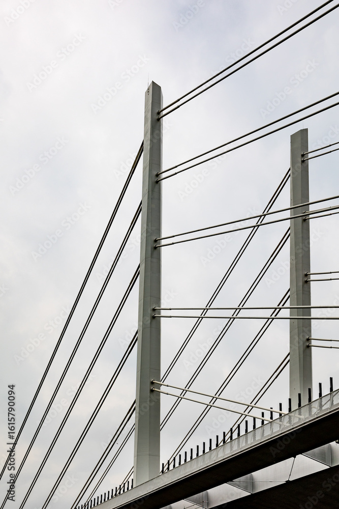 Obraz premium Cable-stayed bridge pillars reaching for cloudy sky