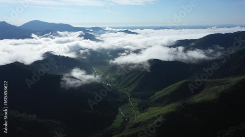 Aerial view of a mountainous and preserved region of the Atlantic Forest, a tropical rainforest in Rio de Janeiro, Brazil. The beauty and biodiversity are the highlights.