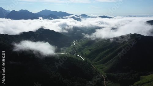 Aerial view of a mountainous and preserved region of the Atlantic Forest, a tropical rainforest in Rio de Janeiro, Brazil. The beauty and biodiversity are the highlights.