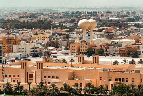Aerial view of the beige-toned Bahrain International Exhibition & Convention Centre and dual water towers stand amidst the cityscape, Manama, Capital Governorate, Bahrain.
