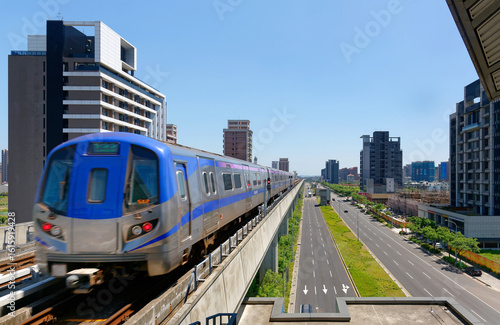 Wallpaper Mural Scenic view of a metro train traveling on elevated rails of Taoyuan Mass Rapid Transit System (Taoyuan International Airport MRT System) under sunny blue sky in Chunli, New Taipei City, Taiwan Torontodigital.ca