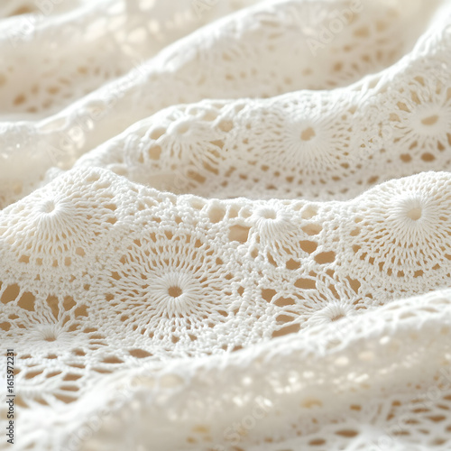 Close-up of white crocheted fabric with circular patterns.