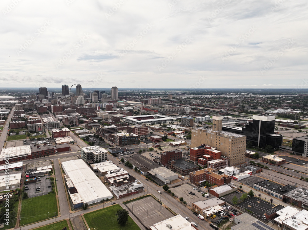 Fototapeta premium Cityscape photo from a drone of downtown St. Louis, MO city on a bright and beautiful summer day with skyscraper buildings and streets in the background.