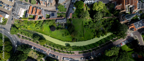 Aerial top down panorama of city gardens with moat of medieval wall in Dutch Hanseatic town of Zutphen in The Netherlands. Communal urban park outside historic stronghold walls