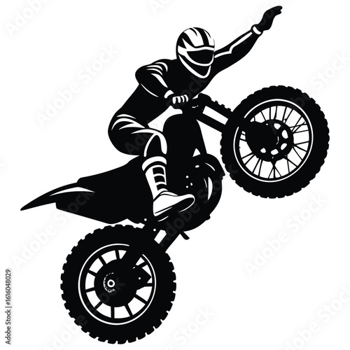 Silhouette of a Motocross Rider Doing a Wheelie Trick on a Bike
