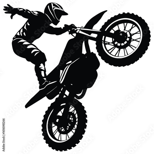 Silhouette of a Motocross Rider Performing a Wheelie with Dramatic Flair