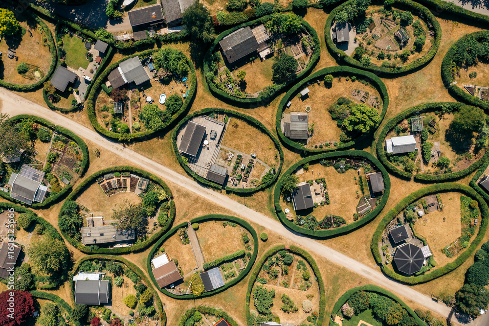 © AmazingAerialAgency - Aerial view of the round gardens, a whimsical landscape of neatly manicured circular plots, each a tiny world of verdant hedges and miniature dwellings, NÃ¦rum, Denmark.