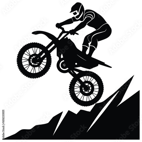 Silhouette of a motocross rider performing a stunt jump over mountainous terrain