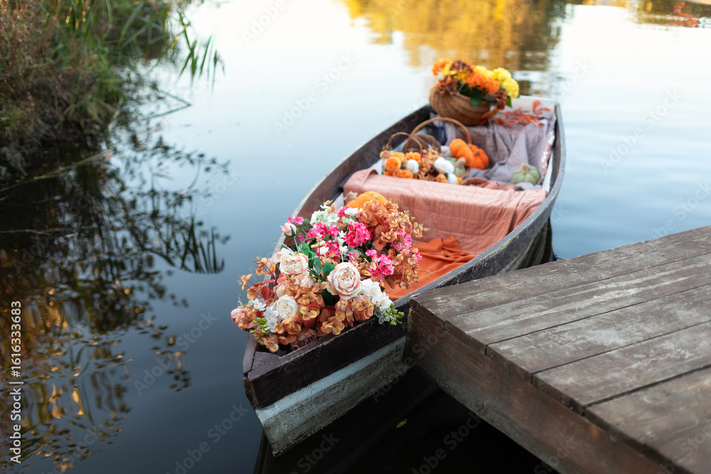 Φωτογραφία A wooden boat decorated with flowers and plant as a wedding decoration on the background of the lake