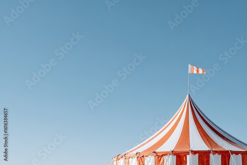 Bright circus tent with red and white stripes against clear blue