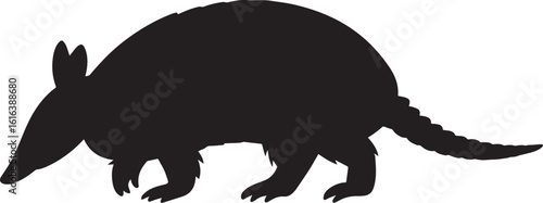 Silhouette of a walking armadillo with pointed snout and armored body black white
