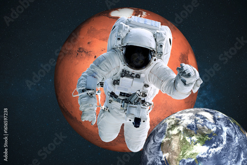Fototapeta Naklejka Na Ścianę i Meble -  An astronaut floats in deep space, framed by the reddish sphere of Mars above and the blue Earth below. Elements of this 3D rendered illustration were furnished by NASA.