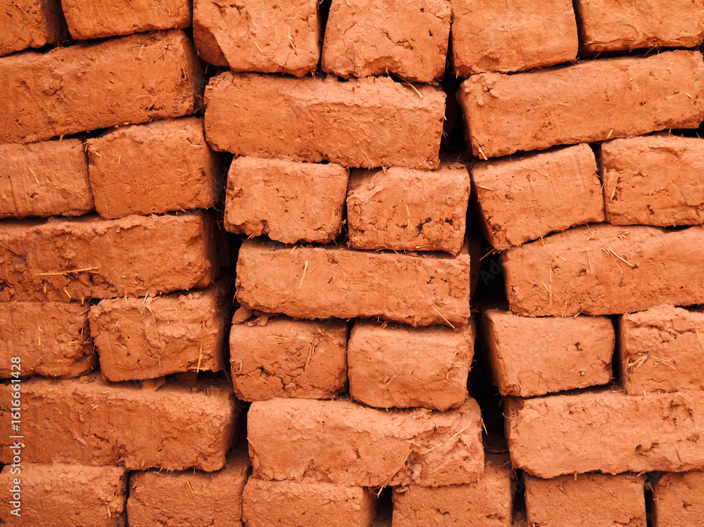 Fototapeta premium Morocco, Ouarzazate, High Atlas mountains. Adobe mud building bricks drying in the sunshine. 