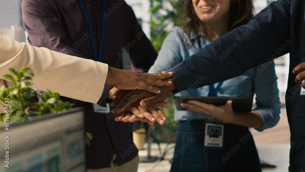 Fototapeta premium Motivated coworkers in diverse office starting project, showing enthusiasm. Joyous multiracial colleagues gathered together to solve company tasks, showing strong bond and camaraderie, camera A