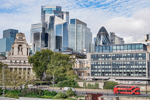 Panoramic view of the city of London business district.
London business center skyscrapers with red transport bus.
