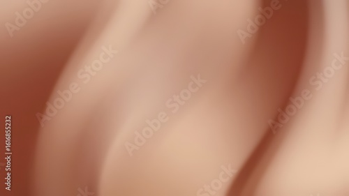 Delicate folds of a light peach fabric.