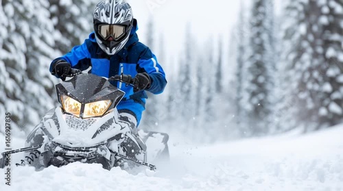 Young person riding a snowmobile in full winter gear - snowy winter forest exploration on personal vehicle in cold weather gear 