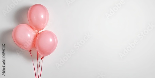 Three pastel pink balloons on a white background