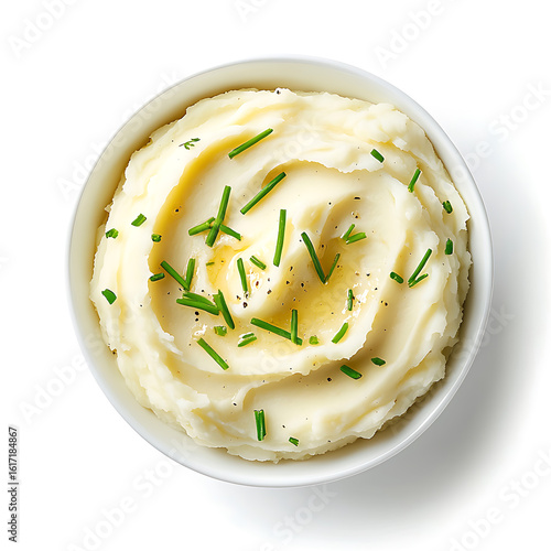 Bowl of creamy mashed potatoes garnished with chives and black pepper