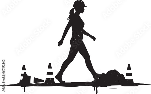 Silhouette of a woman in a hard hat walking through construction