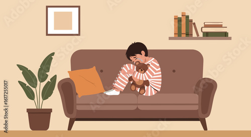 Sad boy hugging a teddy bear on a sofa depicting loneliness and childhood emotional distress in a cozy room
