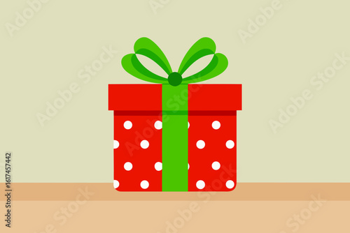 Festive red gift box with white polka dots and green ribbon