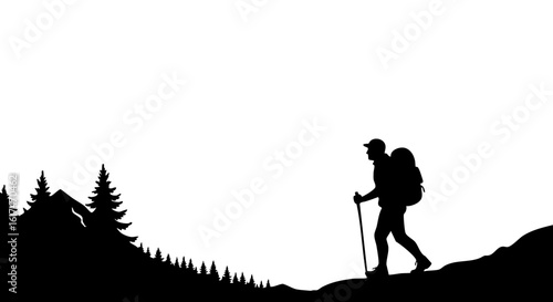 A lone hiker trekking in the mountains silhouetted against the sky.