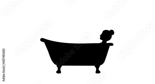 Silhouette of a person relaxing in a classic bathtub.