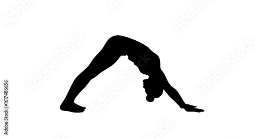 Silhouette of a person performing the downward-facing dog yoga pose.