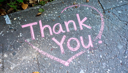 Heart-shaped Thank You message on pavement