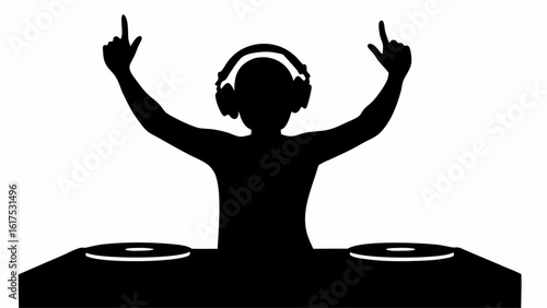 Silhouette of a dj with headphones raising hands in the air behind a turntable with two vinyl records
