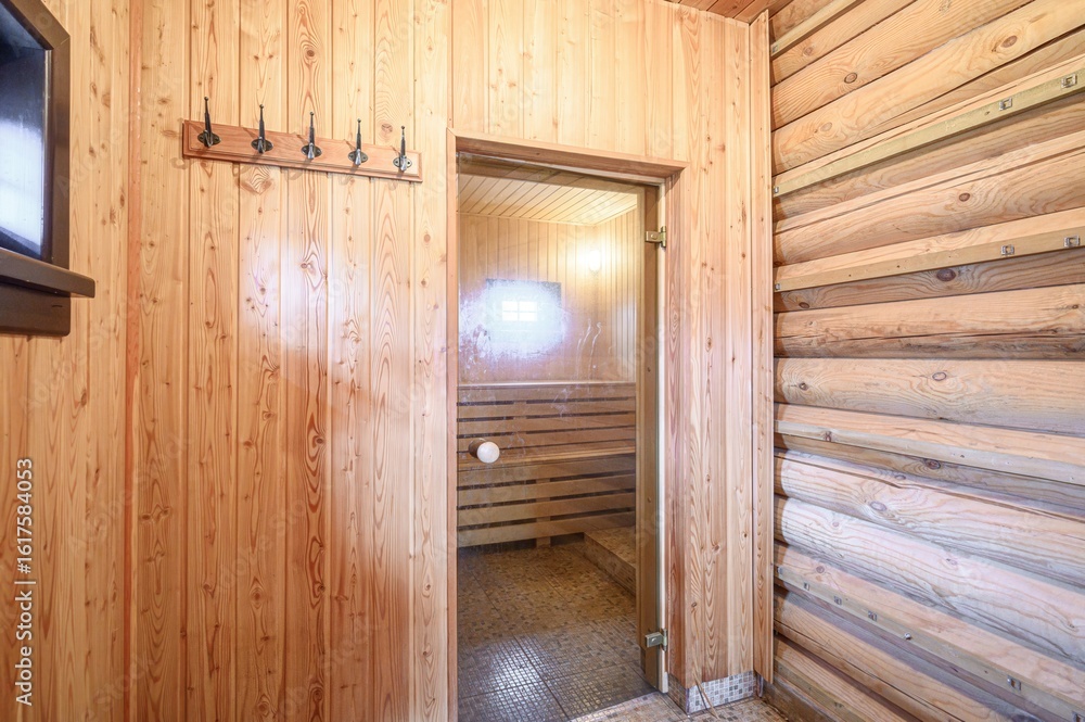 sauna room with wooden walls is shown, including an open glass door leading to a sauna space sauna room with wooden walls is shown, including an open glass door leading to a sauna space