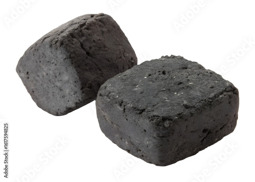 Two dark charcoal briquettes rest on a transparent background. This isolated png image displays the solid fuel carbon forms, ready for use. Transparent.