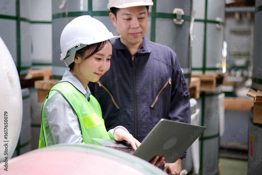 Engineers or workers working on laptop computer and checking product in the metal sheet factory Engineers or workers working on laptop computer and checking product in the metal sheet factory