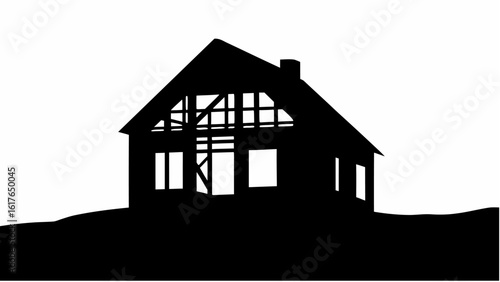 Silhouette of a house under construction with visible frame against a white background in black and white