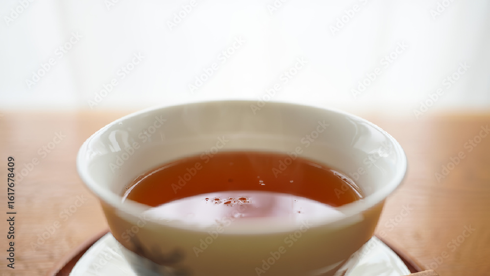 Ceramic tea cup with amber liquid sits calmly on saucer over wood grain table, evoking warmth, simplicity, and morning ritual. AI generated.
Ceramic tea cup with amber liquid sits calmly on saucer over wood grain table, evoking warmth, simplicity, and morning ritual. AI generated.
