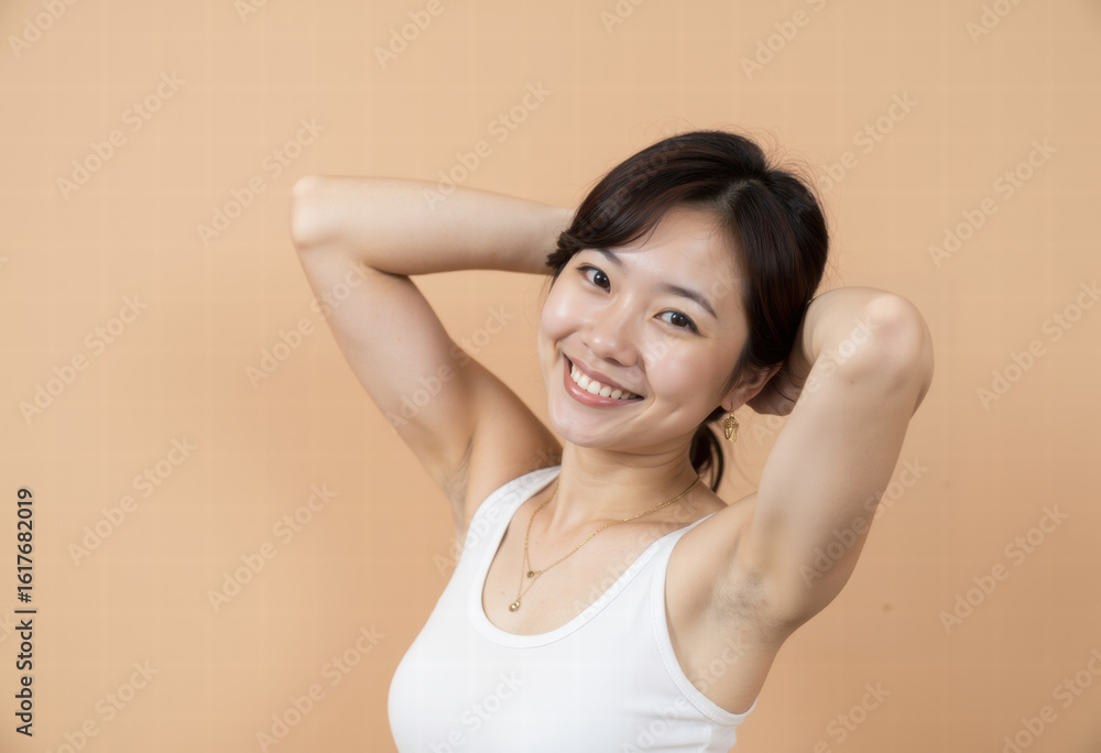 Fototapeta premium A happy young Asian woman with a radiant smile shows off her smooth, clean underarms, promoting body confidence, self-care, and effective hair removal beauty. 