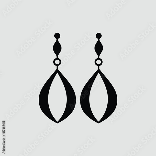 Black teardrop dangle earrings with geometric accents on white background jewelry