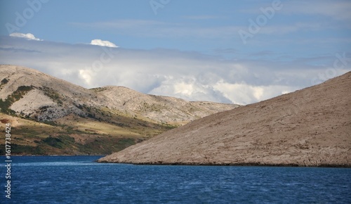 Pag Island, Croatia. Rocks and hills on island Pag.Breathtaking panoramic view of the barren, majestic Pag island across the calm, blue Adriatic Sea