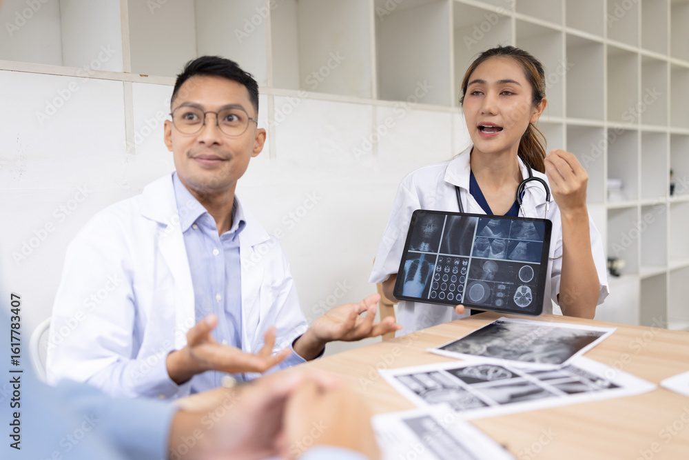 Fototapeta premium Medical team shows and explains MRI having a meeting in conference room at hospital, Medical technology and health care concept.