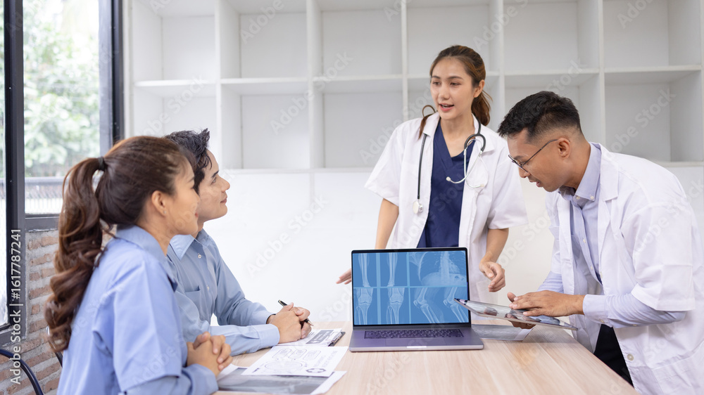 Fototapeta premium Medical team with laptop computer and examine x ray test results for treatment plans in a modern hospital, Healthcare and medical concept.