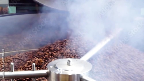 Chachoengsao, Thailand - 22 July : Coffee beans roasted pouring from roaster with heat and smoke on 22 July 2025 in Chachoengsao, Thailand