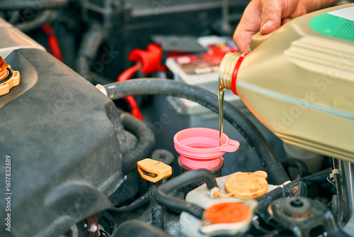 Oil being poured into vehicle engine