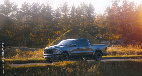 Fotografie Strong pickup truck parked on dirt path