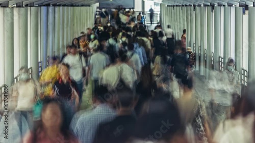 Bangkok bustling urban walkway filled with blurred commuters moving in various directions. Captures the energy of city life, highlighting the diversity of daily urban activities