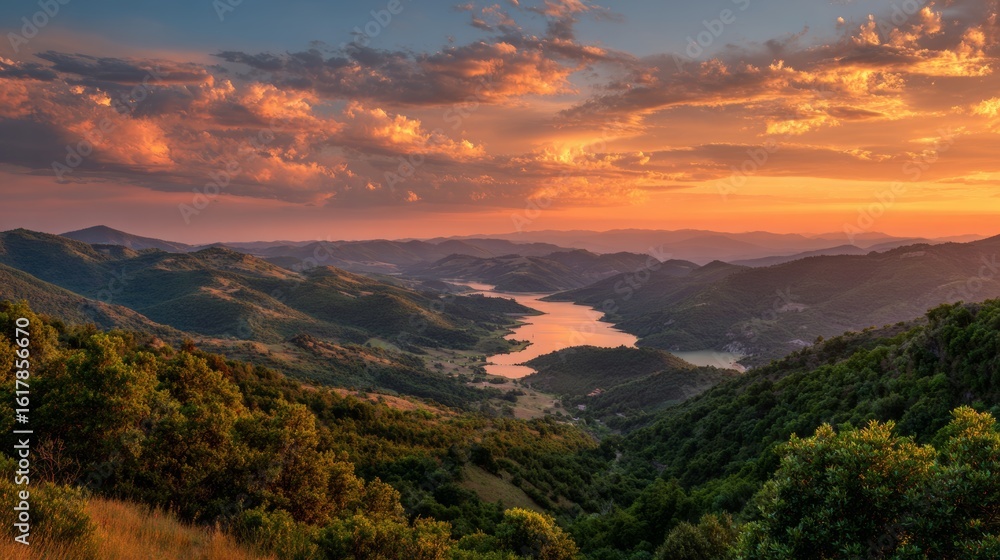 Fototapeta premium Orange and Pink Sunset Over a Valley Between Hills and Lake