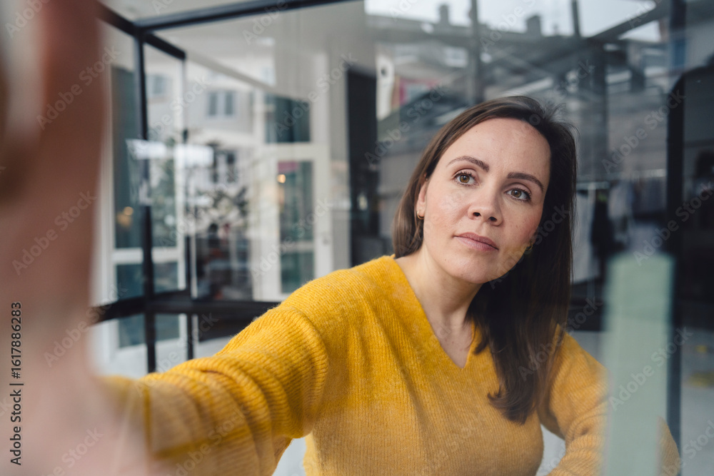 Confident businesswoman in yellow sweater in modern loft office Confident businesswoman in yellow sweater in modern loft office