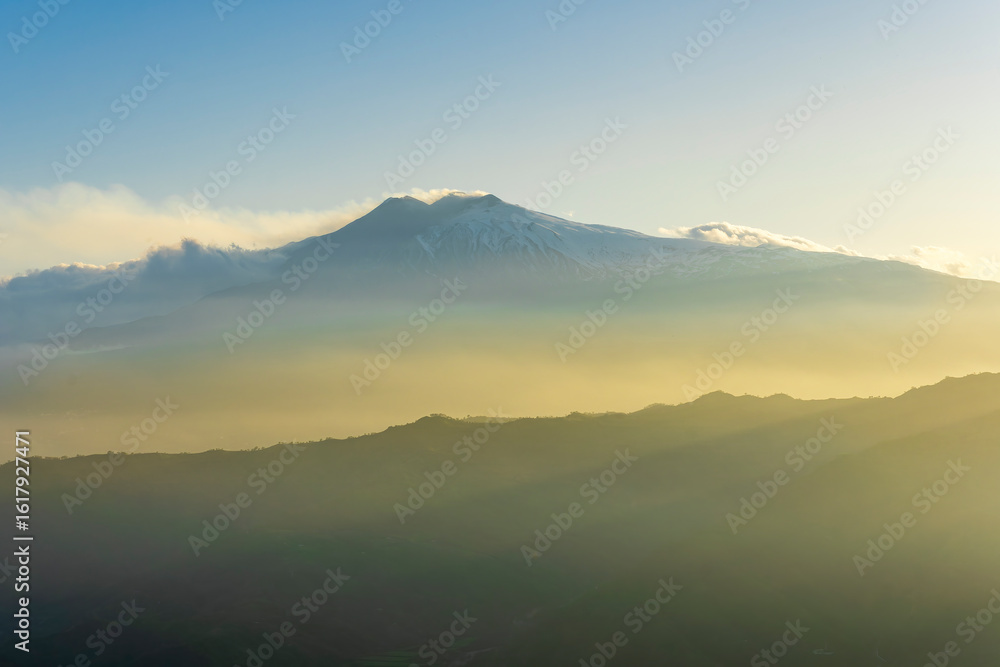 Obraz premium beautiful mountain sunset landcape with great magestic mountains and amazing slopes and canyons with evening clouds. Panorama of vulcano Etna in Sicily, Italy.